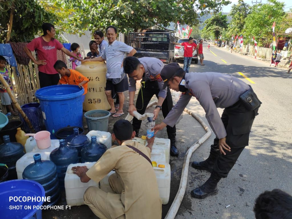 Bantu Kesulitan Warga, Kapolsek Hu’u dan Kasat Sabhara Polres Dompu Bagikan Air Bersih